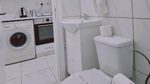 A modern bathroom with a toilet, sink, and shower. - 109 LIM 1 - Stay Olive Studio (Limassol)