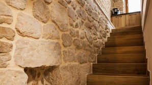 A stone wall with a wooden staircase. - Lovely home in Zmijavci with private swimming pool, can be inside or outside (Zmijavci)