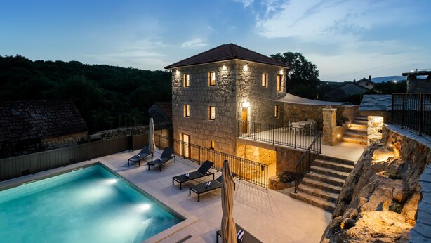 A stone building with a swimming pool, outdoor seating, and a staircase leading to a balcony. - Lovely home in Zmijavci with private swimming pool, can be inside or outside (Zmijavci)