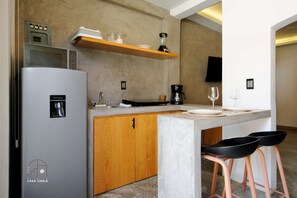 Fridge, microwave, coffee/tea maker, cookware/dishes/utensils