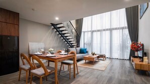 Deluxe Apartment | Living area | 50-inch Smart TV with digital channels - NVT Housing - PentStudio West Lake Hanoi (Hanoi)