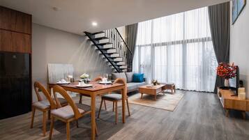 Deluxe Apartment | Living area | 50-inch Smart TV with digital channels
