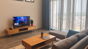Deluxe Apartment | Living area | 50-inch Smart TV with digital channels - NVT Housing - PentStudio West Lake Hanoi (Hanoi)
