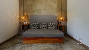A modern bedroom with a large bed, two bedside tables, and hanging pendant lights. - Unmatched Modern PH Loft in the Center of la Punta (Brisas de Zicatela)