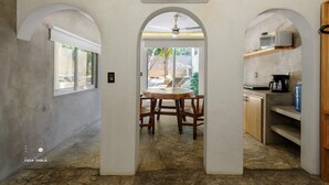 A modern kitchen with an arched doorway leading to a dining area. - Spectacular Suite Steps Away From Center La Punta! (Brisas de Zicatela)