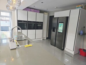 Enjoy cooking in this well-equipped kitchen with a refrigerator, oven, and microwave, plus ample storage in a large cabinet.