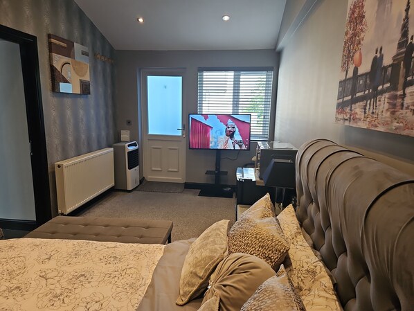 Relax in comfort with a large bed, TV, and seating area.