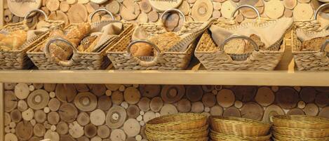 A bakery display with various breads and baskets.