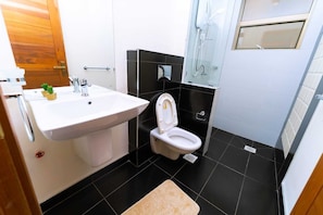 Deluxe Apartment, Balcony, City View | Bathroom | Shower, slippers, towels, soap