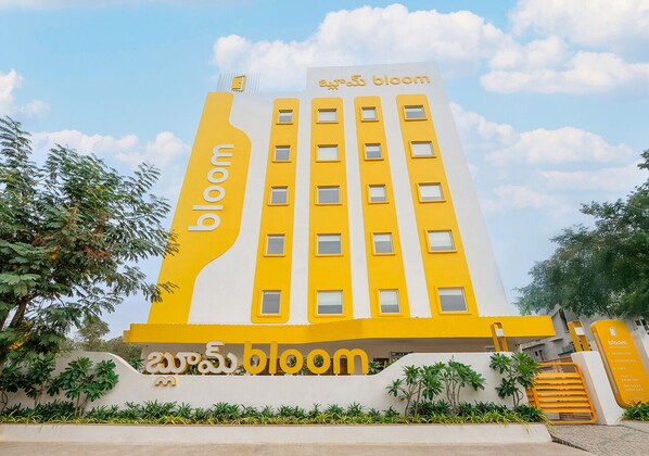 En byggnad med en gul fasad och namnet ”bloom” tydligt synligt.