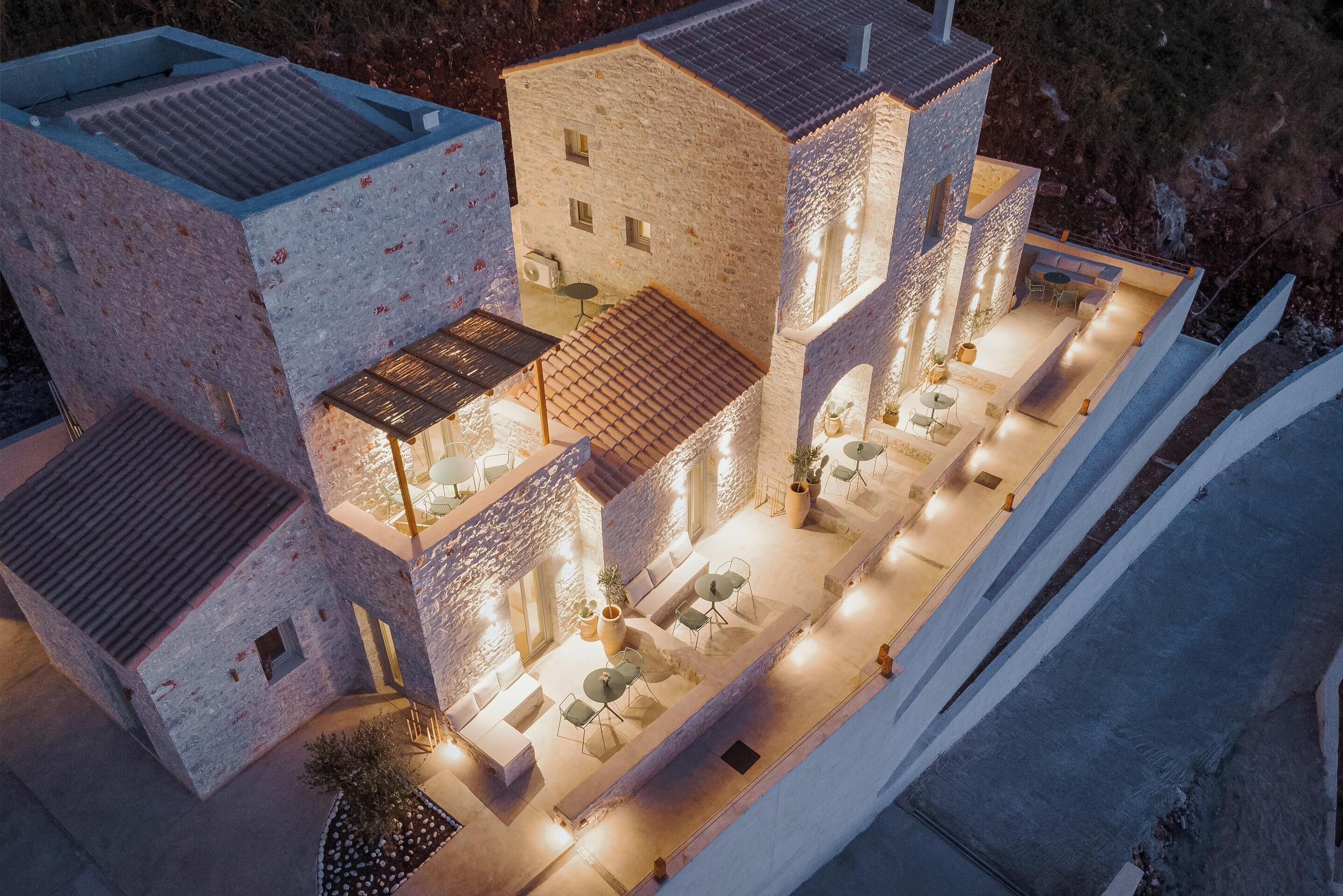 A model of a modern multi-story building with a rooftop terrace and outdoor seating area.