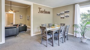 A dining area with a table and chairs, a ceiling fan, and a wall with the name "Jackson". - Jackson Family Home ~ 5 Mi to Downtown! (Jackson)