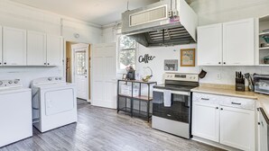 A kitchen with white cabinets, a built-in oven, a microwave, and a coffee station. - Jackson Family Home ~ 5 Mi to Downtown! (Jackson)