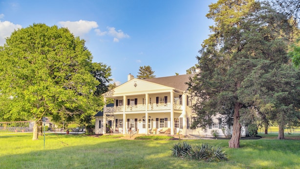 A two-story house with a porch and a large lawn. - On 7 Acres! Riverfront Estate w/ Views in Denton (Denton)