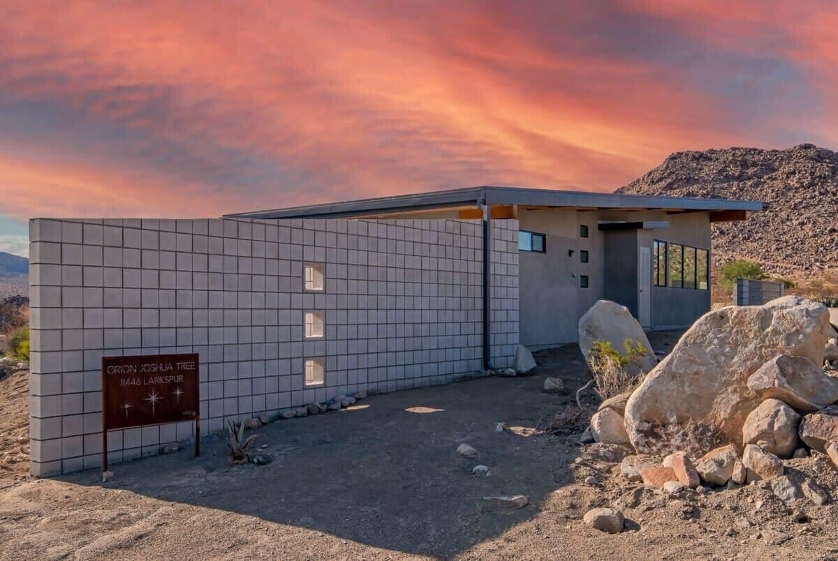 A modern building with a sign indicating the Orion Joshua Tree location.