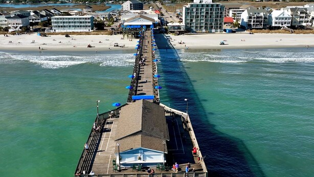 A pier extending into the water with a covered seating area and a building at the end. - Inlet Paradise A - Your Perfect Coastal Escape! (Murrells Inlet)