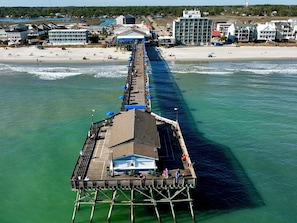 A pier extending into the water with a covered seating area and a building at the end. - Inlet Paradise A - Your Perfect Coastal Escape! (Murrells Inlet)