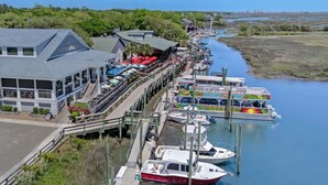 A riverside restaurant with outdoor seating and a dock for boats. - Inlet Paradise B Beautiful Condo Walking Distance to Beach! (Murrells Inlet)