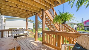 A wooden deck with a bench and a chair, a staircase, and a potted plant. - Inlet Paradise B Beautiful Condo Walking Distance to Beach! (Murrells Inlet)