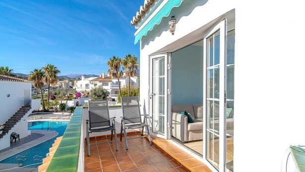A rooftop pool area with a sliding glass door leading to a balcony with a sofa. - Edf Papillon (Nerja)