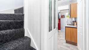 A modern kitchen with wooden cabinets and a built-in stove. - Spacious 2 bed House With Free on Street Parking (Birmingham)