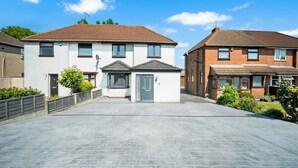 A residential street with two houses, each with a front door, windows, and a small garden area. - Family/contractors 3 bed House/parking/sleeps 7 (Bilston)