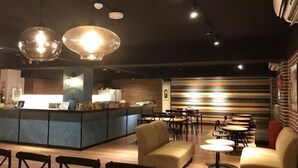 A modern cafe with a counter, seating area, and decorative lighting. - Jiufen Sunshine (New Taipei City)