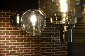 A brick wall with hanging spherical light fixtures. - Jiufen Sunshine (New Taipei City)