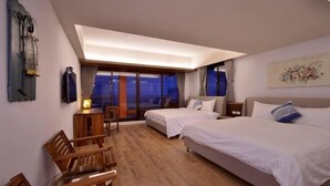 A hotel room with two beds, a desk, a chair, and a large window with a view. - Jiufen Sunshine (New Taipei City)