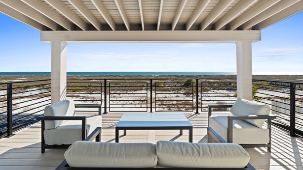 A covered outdoor seating area with a view of the beach and ocean. - Costa-Florida: 7 Bedrooms, Private Pool, Community Pool and Gym (Mexico Beach)