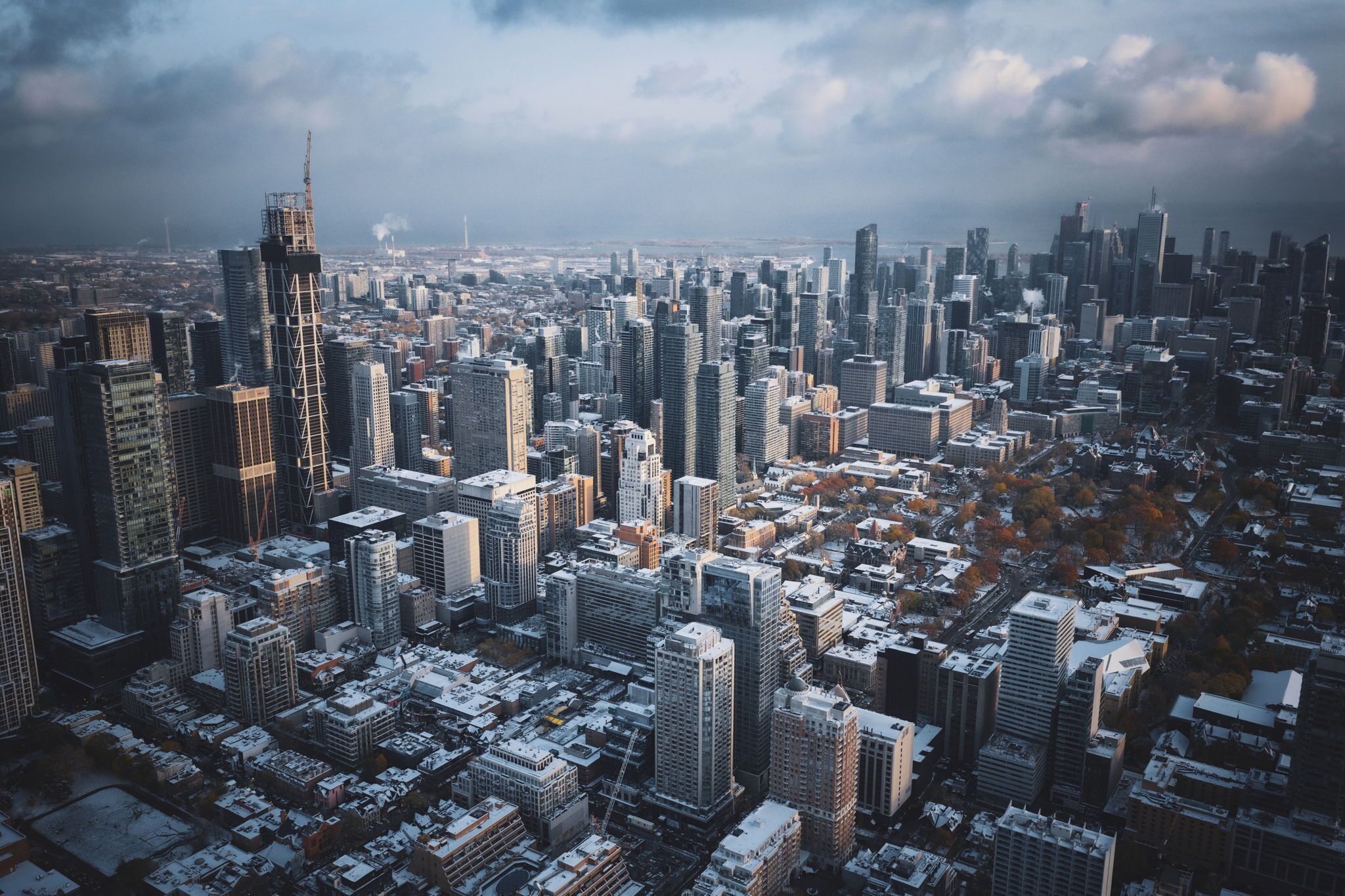 A cityscape with numerous high-rise buildings, some under construction, and a mix of residential and commercial structures.