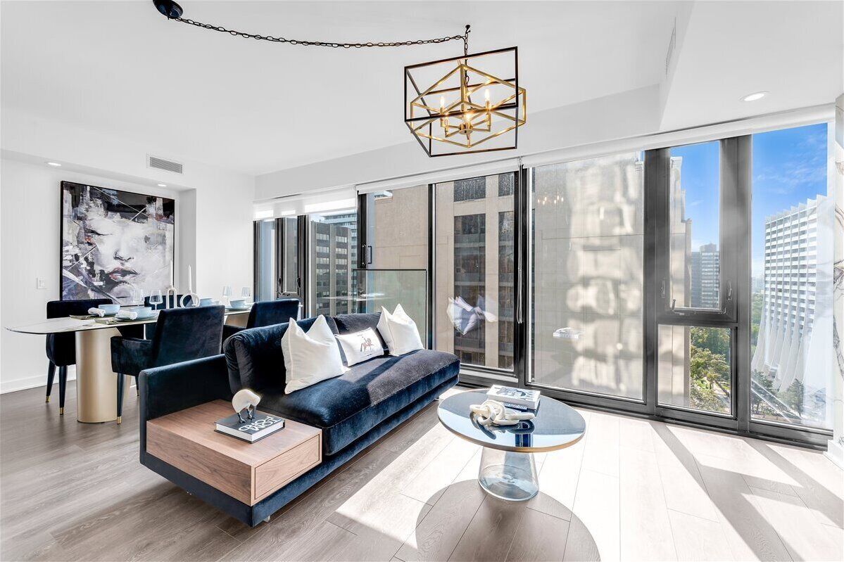 A modern living room with a sofa, coffee table, and artwork.