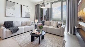 A modern living room with two sofas, a coffee table, and a large window with curtains. - Downtown Dream Sea View Near Dubai Mall (Dubai)
