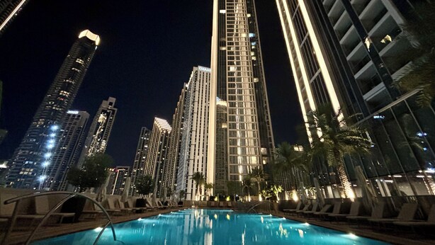 A nighttime view of a high-rise building with a pool area in the foreground. - Downtown Dream Sea View Near Dubai Mall (Dubai)