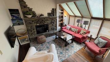 Smart TV, fireplace, books, printers