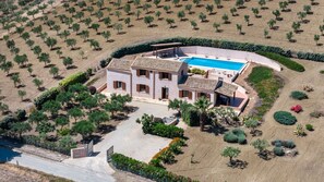 An aerial view of a property with a swimming pool, multiple buildings, and landscaped gardens. - Villa sui Colli Ericini con Piscina by Wonderful Italy (Erice)