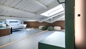 A modern bedroom with a skylight, a bed, and a desk area. - Settimo Apartment With Terrace by Wonderful Italy (Palermo)