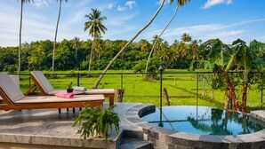 A poolside area with lounge chairs, a small pool, and a view of a lush green landscape. - Nuwans Countryside Hideaway (Tangalle)