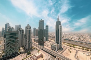 A high-rise urban skyline with modern architecture, including a prominent building with a spire.