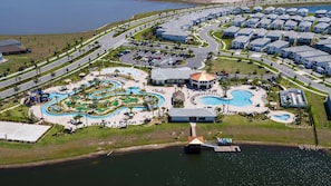 A resort with a central pool area, a marina, and a residential complex. - Last Minute Disney! Private Pool, Hot Tub, Game Room & Themed Bedrooms. Book Now! #115127 (Orlando)