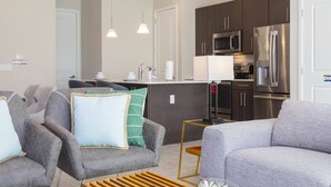 A modern kitchen with dark cabinets, stainless steel appliances, and pendant lighting. - Disney! Private Pool, Hot Tub & Themed Bedrooms. Book Now! #VDR14 (Orlando)
