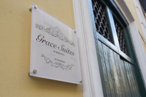 A sign for "Grace Suites" with a phone number. - Grace Suites (Sorrento)