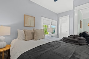 This bedroom offers a sanctuary of comfort and sophistication, inviting the occupant to unwind and recharge in a space that reflects a thoughtful and intentional approach to interior design. - New! Cozy 2BR near Lake at Anchor Bay (New Baltimore,)