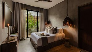 A modern bedroom with a bed, bedside table, and a view of greenery outside. - Casa Kutzi Kutzi Paradise Villa Beach Club Access (Tulum)