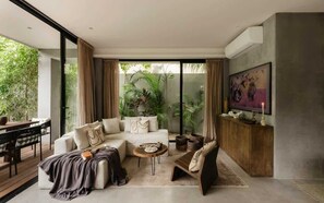 A modern living room with a sectional sofa, a coffee table, and a TV on a wooden cabinet.