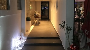 En modern hall med en trappa som leder upp till ett väl upplyst område.