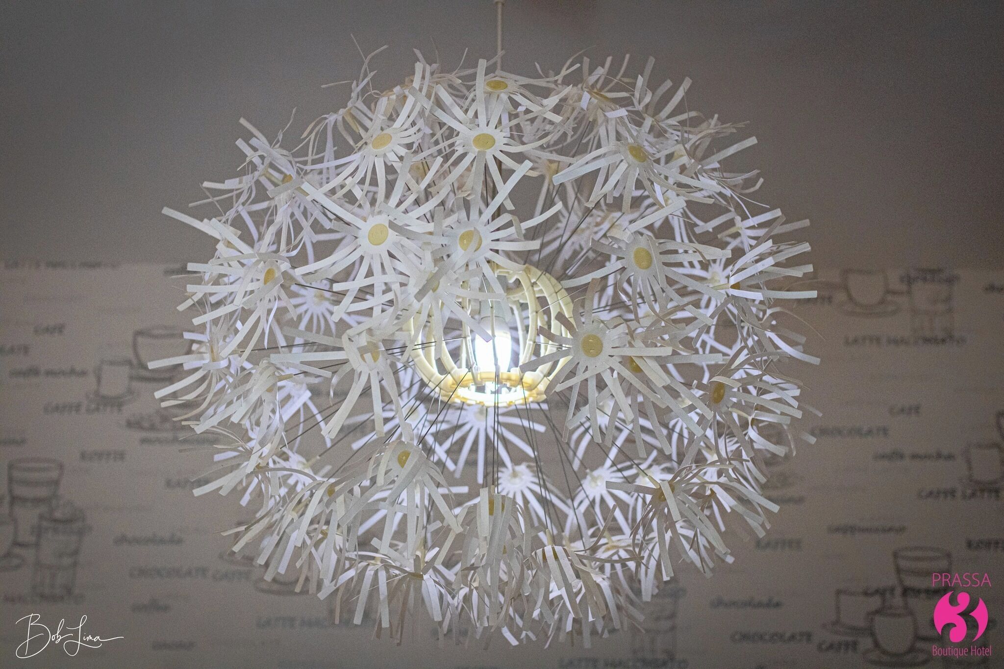 A chandelier with a circular design made of white, paper-like materials.