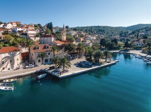 A coastal town with a marina, historic buildings, and a prominent church tower. - Holiday Home Aurora - Three bedroom Holiday Home (Postira)
