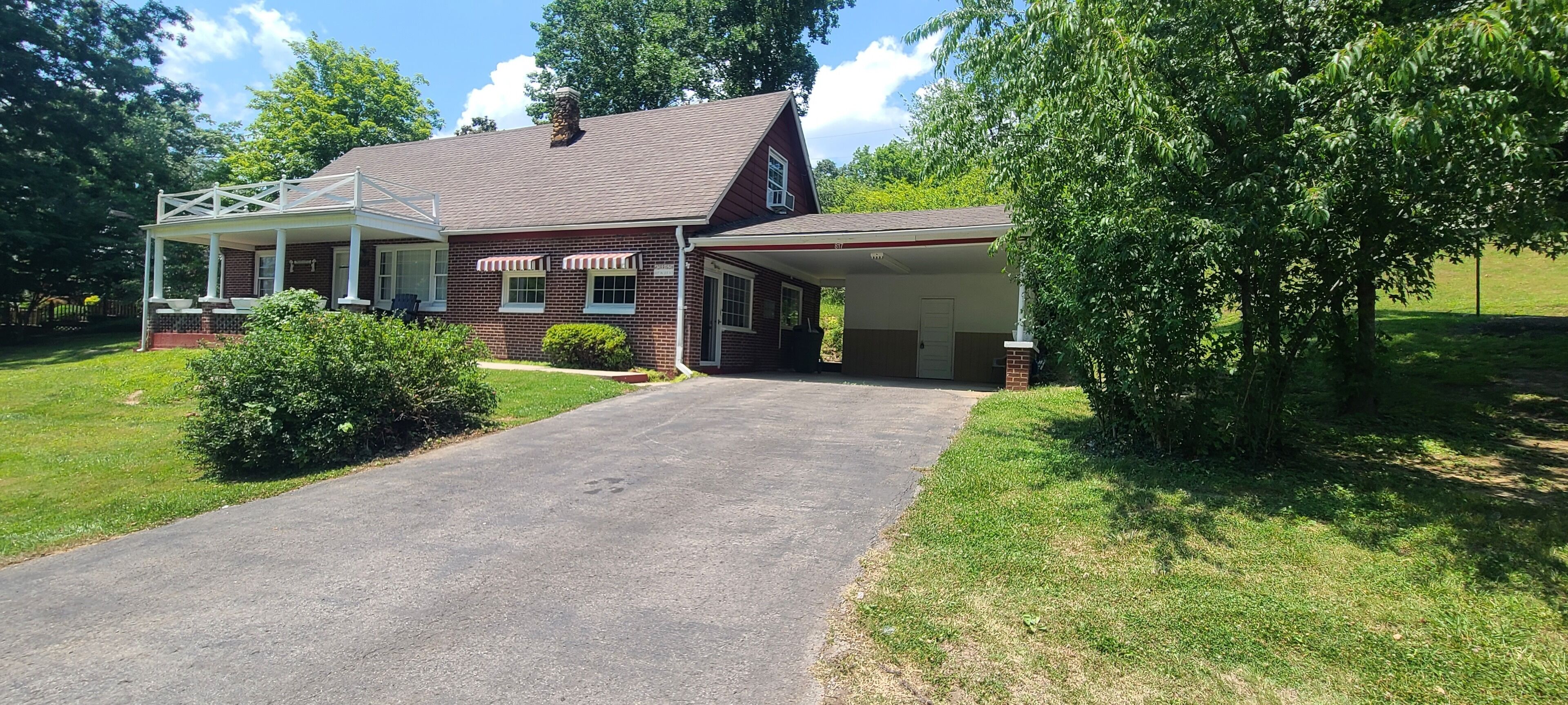 A two-story house with a covered porch and a garage.