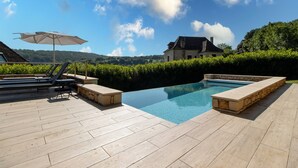 A swimming pool with a wooden deck, lounge chairs, and an umbrella. - Holiday Home 'Gite Les Hauts De L'ouysse' with Private Pool, Wi-Fi and Air Conditioning (Lacave)